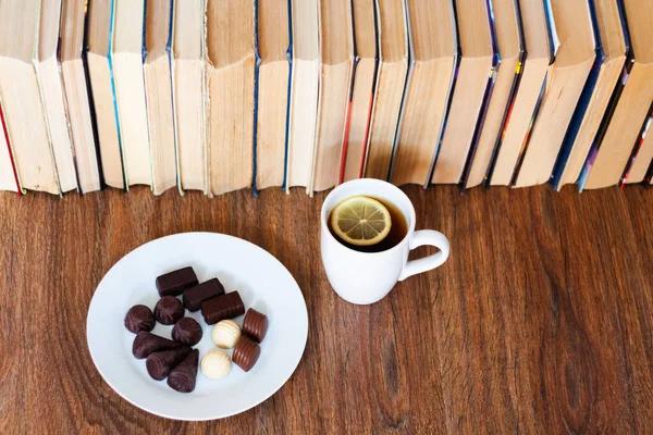 Cup Tea Chocolate Candies White Plate Stack Old Book Wooden Stock Image
