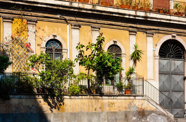 Sicily, facade of old baroque building in Catania, old street with traditional architecture of Italy
