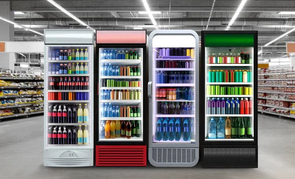Soda pop drinks and soft drinks in Fridge. Soda pop cans and plastic bottles in vertical freezer at supermarket. Suitable for presenting new beer bottles and packaging or label designs among many others. Glass door fridge Horizontal photo mockup.