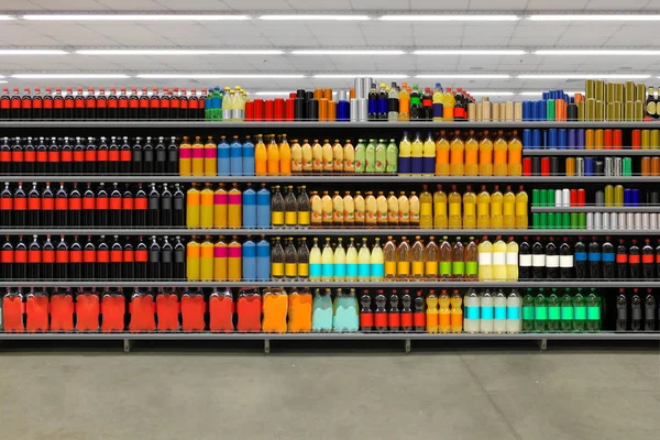 Juice bottles Various bottles of juice, soda, water, vitamins on shelf at supermarket. Suitable for mockup and business presentation.