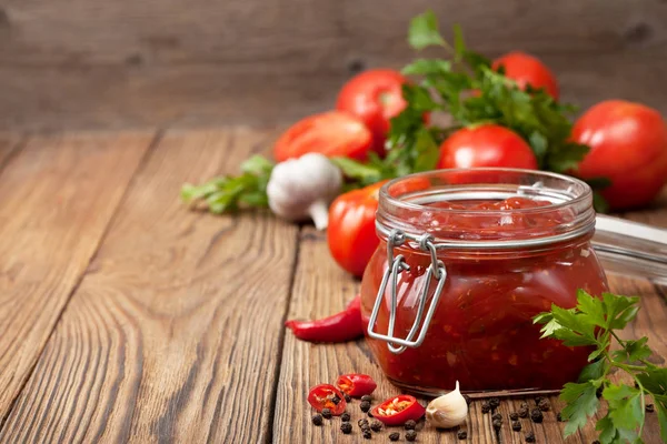 Tomato sauce in a glass jar — Stock Photo, Image