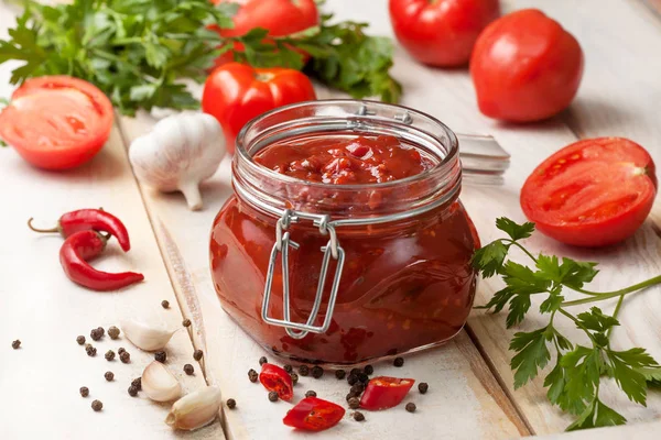 Tomato sauce in a glass jar — Stock Photo, Image