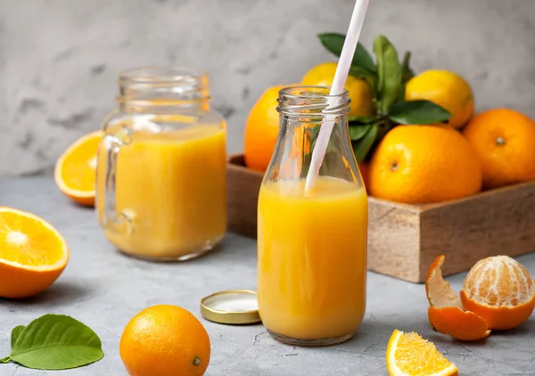 Orange juice in glass bottles — Stock Photo, Image