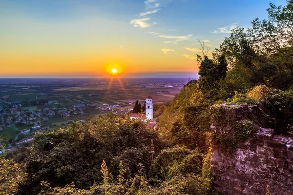 Sunset from a hill with a church down to the vineyards — Stock Photo, Image