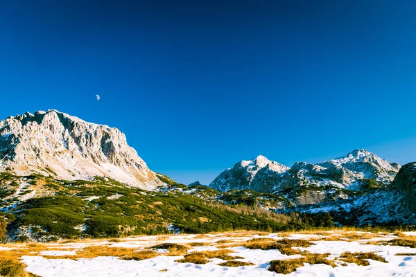 Moon is rising behind the mountains — стоковое фото