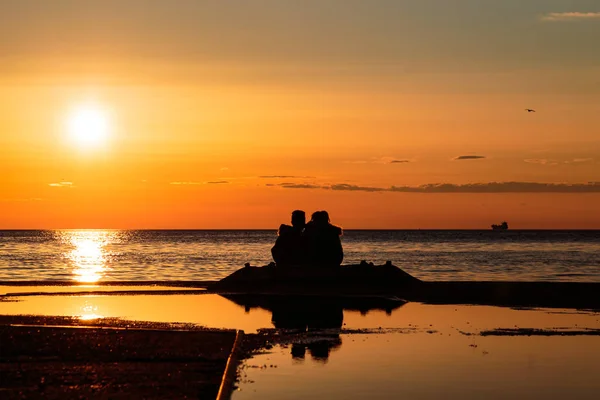 Paret tittar på en romantisk solnedgång — Stockfoto