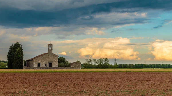 Storm reaching a little church in the fields — Stock Photo, Image