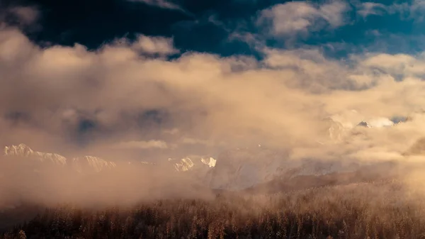 Mangart capped by the fog in a winter day — Stock Photo, Image