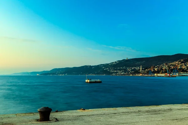 Colorful sunset in front of the city of Trieste — Stock Photo, Image