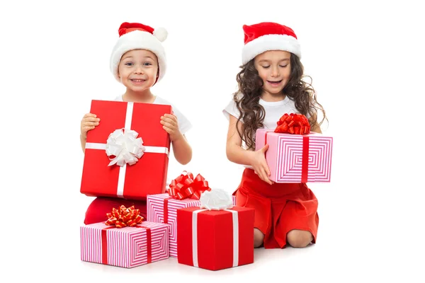 Happy little kids in Santa hat with Christmas gift boxes — Stock Photo, Image