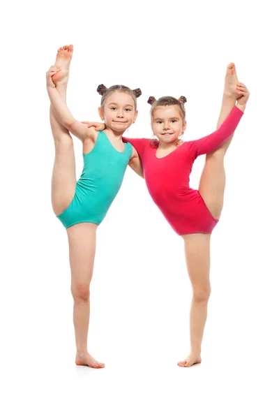 Flexible little girls gymnasts, isolated on white background — Stock Photo, Image