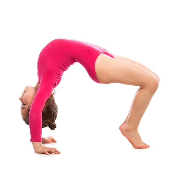 Flexible little girl gymnast on a white background — Stock Photo, Image