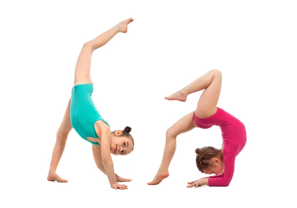 Flexible kids gymnasts doing acrobatic feat, isolated on white background — Stock Photo, Image