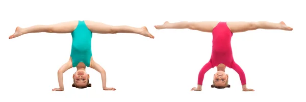 Flexible kids gymnasts standing on head, isolated white background — Stockfoto