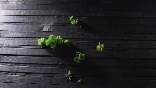 Chopped parsley falls to the wooden board fresh — Stock Video