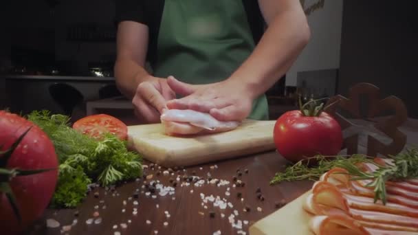 Sliding zooming shot chef slices chicken fillet — Stock Video