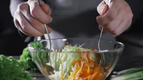 Повар делает овощной салат с капустой и морковью — стоковое видео