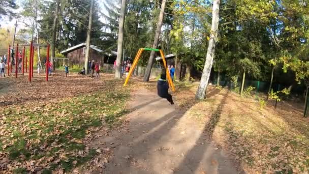 ポーランドのワルシャワ 2019年10月27日 遊び場でスイングを楽しんでいる男の子 — ストック動画