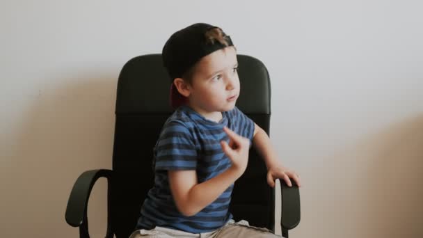 Αγόρι Κάθεται Μαύρη Καρέκλα Γραφείου Σαν Αφεντικό Και Βρίζει — Αρχείο Βίντεο