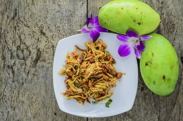 Mango salad from top view on wooden floor. — Stock Photo, Image