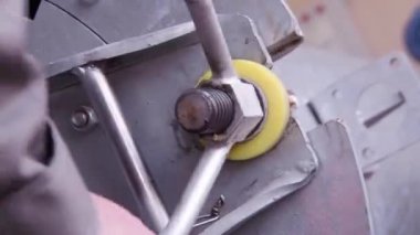 Beyaz adam halı ürünleri için bir santrifüjün kapağını kapatıyor..