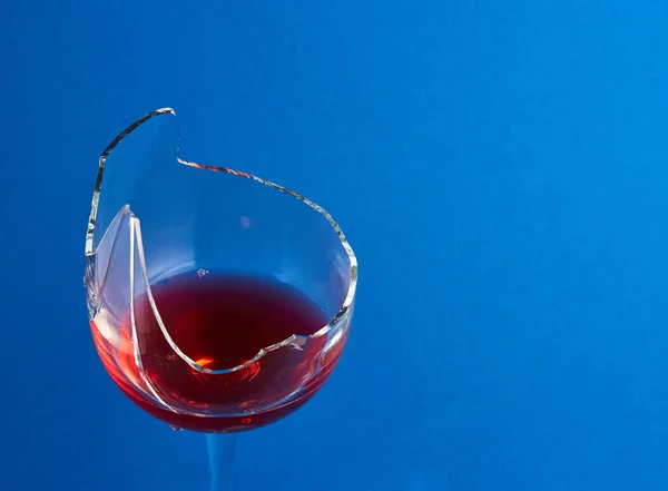 Gebroken Glas Met Rode Wijn Een Blauwe Achtergrond Bovenaanzicht — Stockfoto