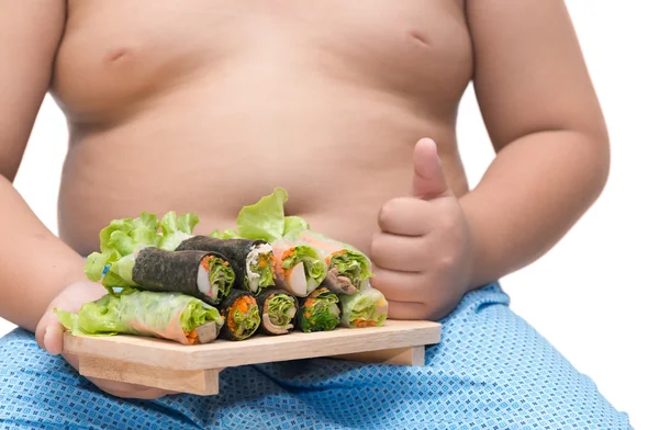 salad roll on fat boy hand isolated on white background