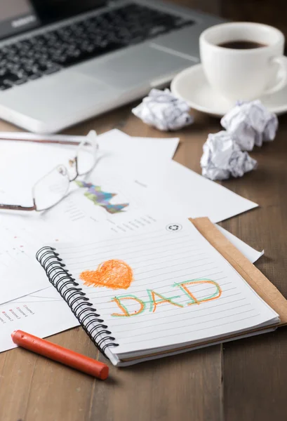 love dad text on notebook on workdesk.