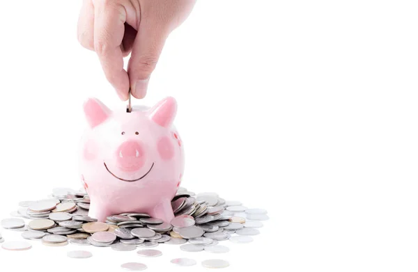 Biznesmen wprowadzenie monet do pink piggy bank na białym tle — Zdjęcie stockowe