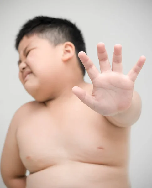 Obeso chico mostrando stop gesto en gris fondo — Foto de Stock