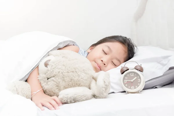 Niedliche Mädchen schlafen und umarmen Teddybär. — Stockfoto