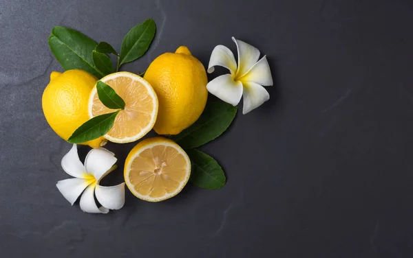 Frische Zitronenscheiben auf schwarzem Marmor — Stockfoto