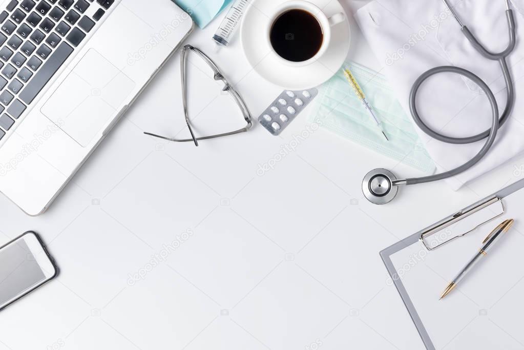 doctor desk table with stethoscope, coffee, Medical gown and not