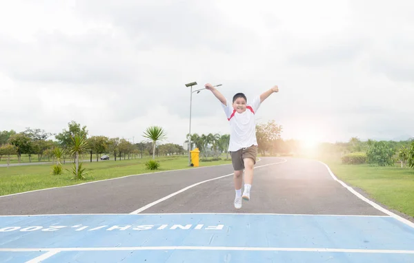 Happy asian fat boy running to the finished line.