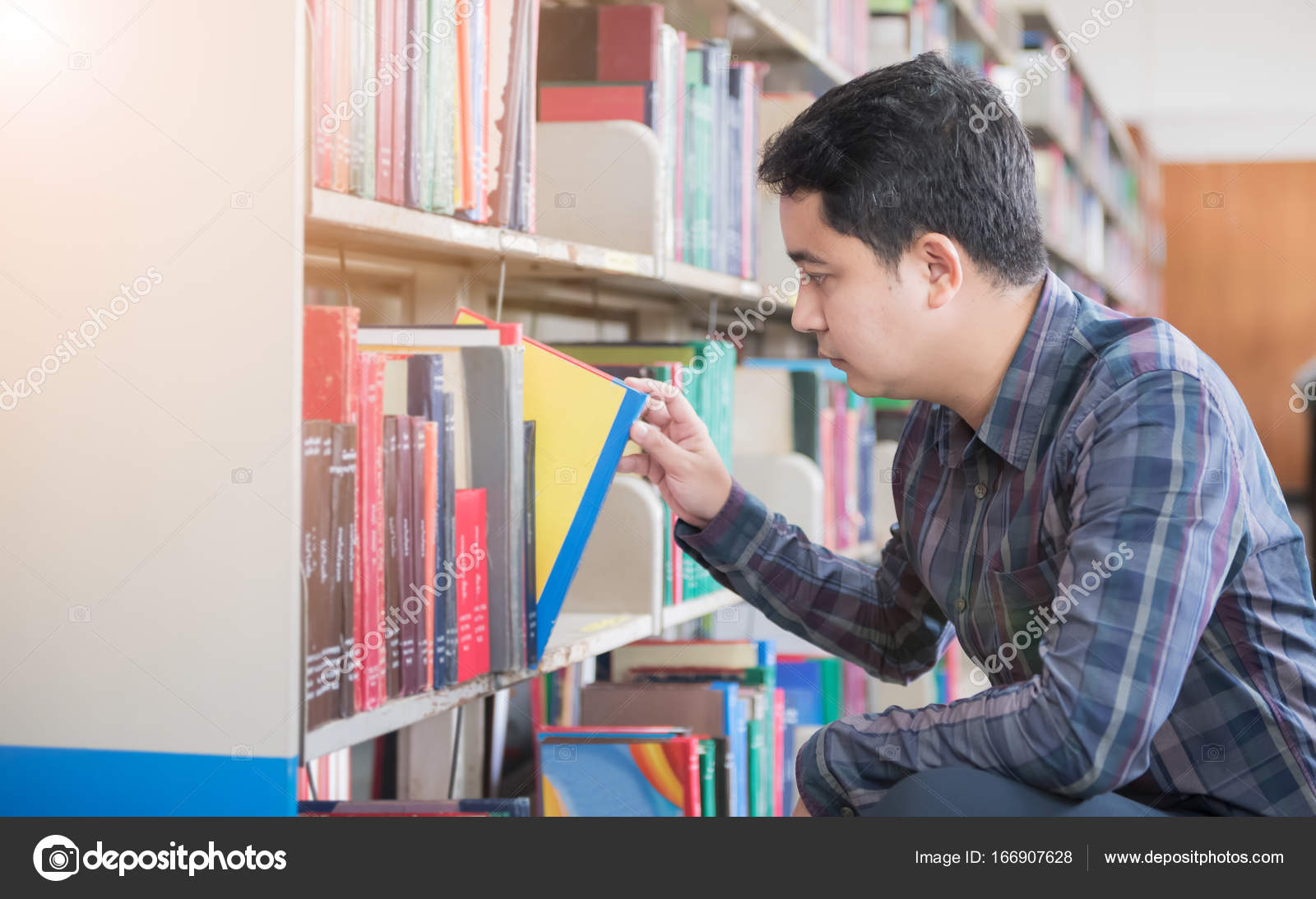 Smart Student Find Book On Bookshelf In Library Stock Photo