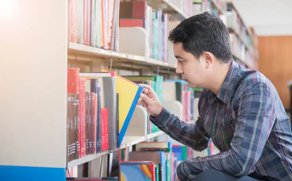 Okos tanuló könyv-ra könyvespolc található könyvtár — Stock Fotó