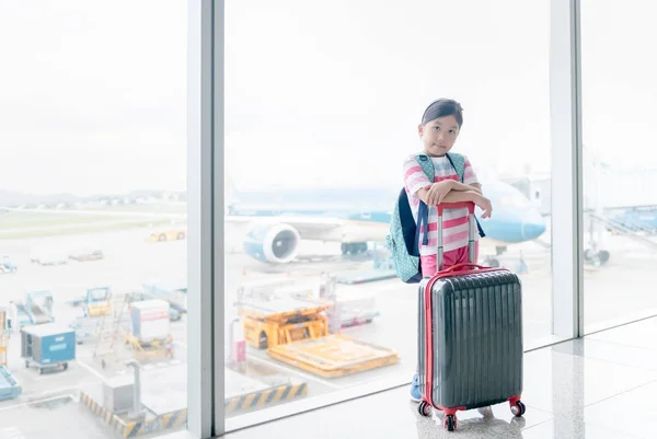 Cute asian stand with baggage in airport — Stock Photo, Image