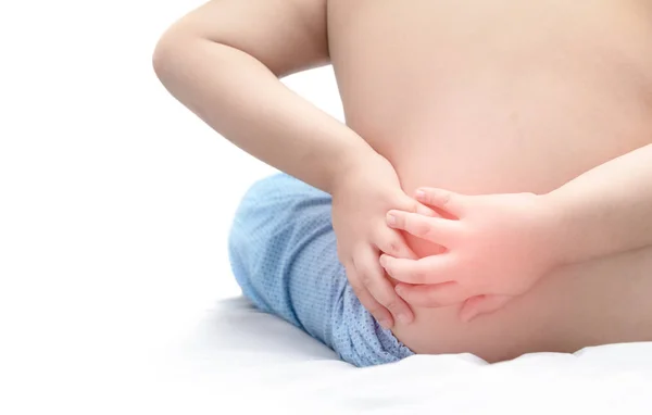 Boy holding his back in pain and suffers from backache — Stock Photo, Image