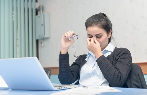 Tired businesswoman massaging nose bridge — Stock Photo, Image