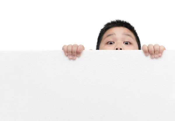 Surprised boy holding empty horizontal white banner foam board Royalty Free Stock Photos