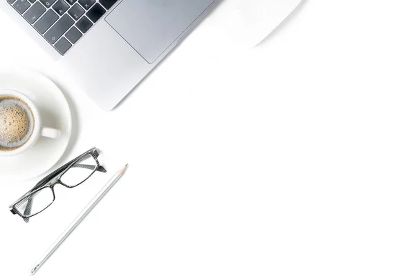 Desk with laptop, eye glasses, pencil and a cup of coffee