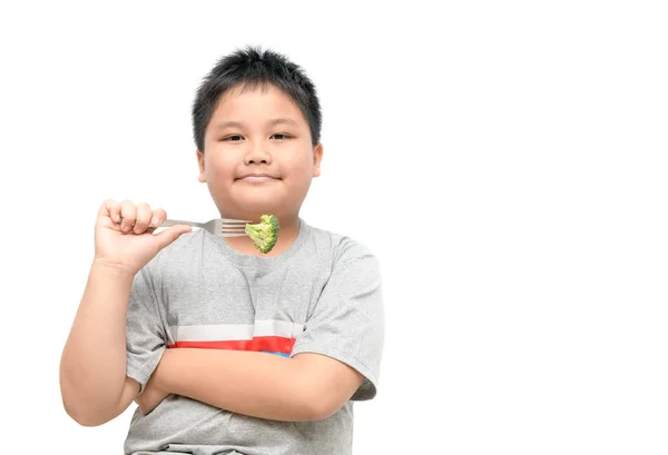 Fettleibige dicke Junge mit Brokkoli auf der Hand isoliert — Stockfoto