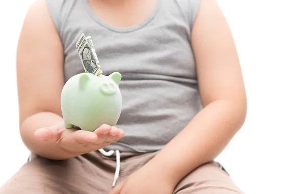 Menino gordo segurando porquinho de volta com nota de dólar — Fotografia de Stock