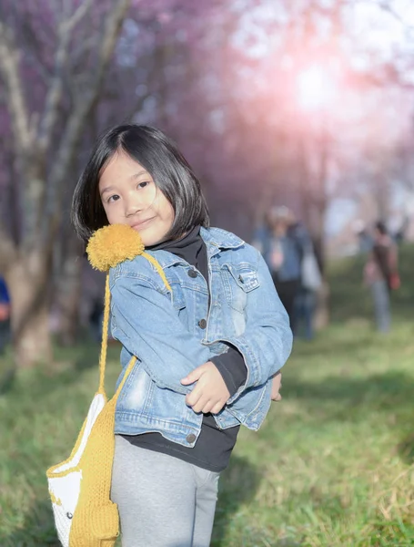 Happy traveler girl smile on cherry blossom background,