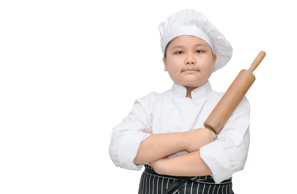 Bonito menino chef segurar rolando pino com chapéu de cozinheiro — Fotografia de Stock