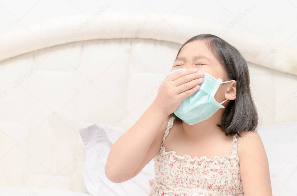 girl wear protection mask and sneeze