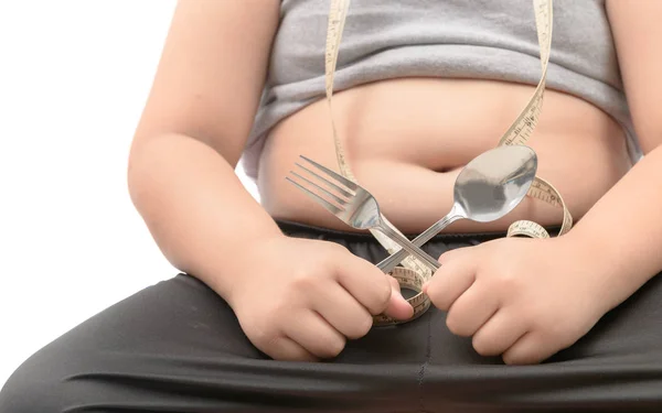 Fettleibiger dicker Junge hält Gabel und Löffel isoliert — Stockfoto