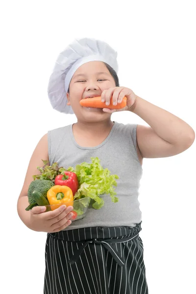 Menino obeso chef comer cenoura isolada — Fotografia de Stock