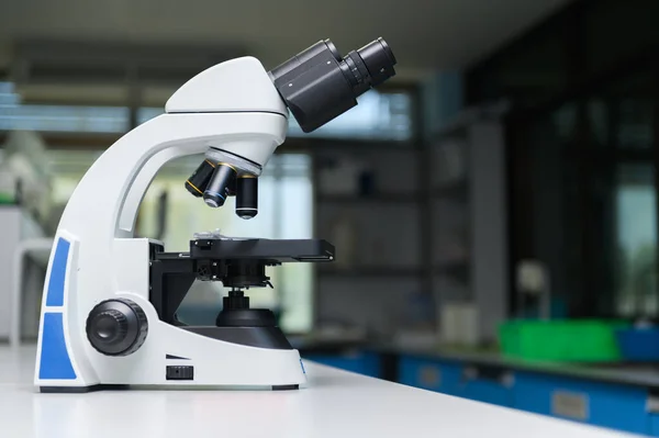 Microscope in laboratory room, science concept