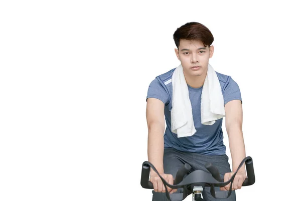 Ajuste jovem usando bicicleta de exercício isolado em branco — Fotografia de Stock